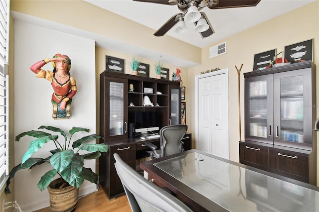 office space with visible vents, light wood-style flooring, and ceiling fan