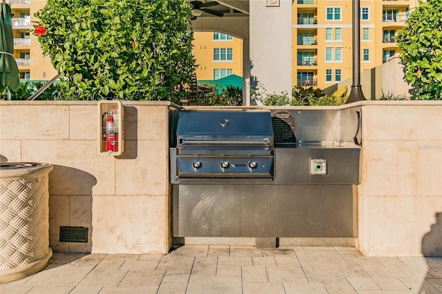 view of patio / terrace featuring an outdoor kitchen and a grill