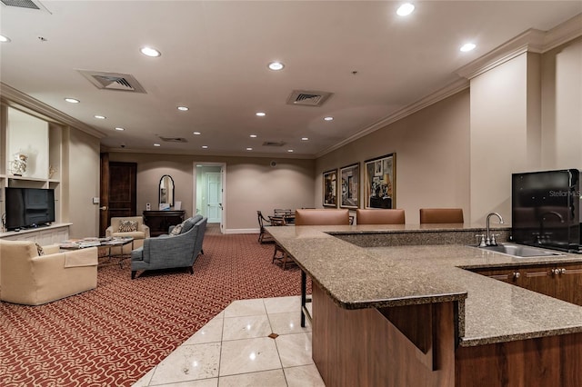 kitchen featuring light tile patterned floors, visible vents, recessed lighting, a sink, and crown molding