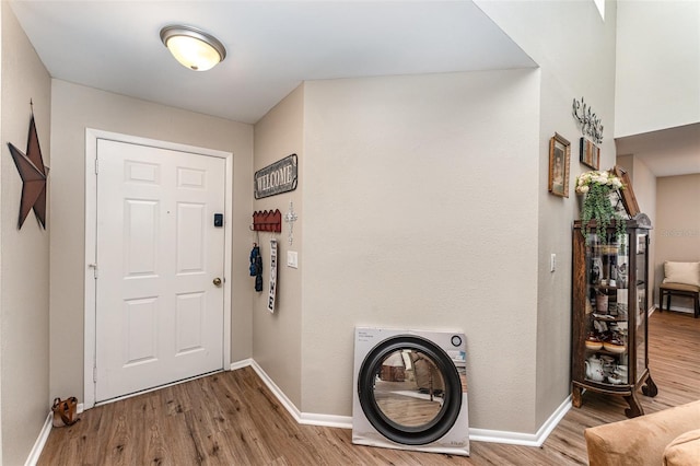 foyer entrance with wood finished floors and baseboards