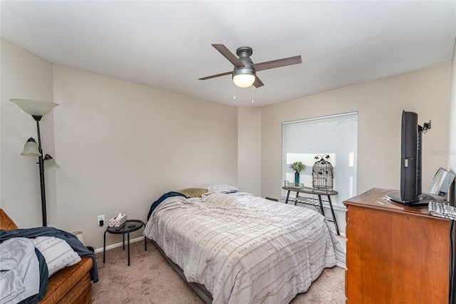 bedroom featuring baseboards, light carpet, and ceiling fan