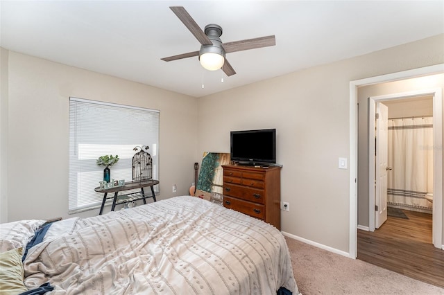 carpeted bedroom with ceiling fan and baseboards