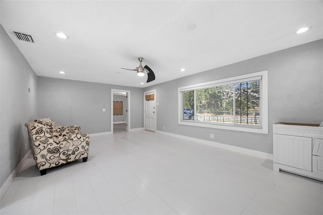 sitting room with recessed lighting, visible vents, and baseboards