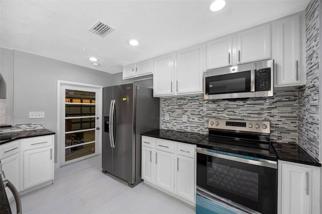 kitchen with white cabinetry, decorative backsplash, and appliances with stainless steel finishes