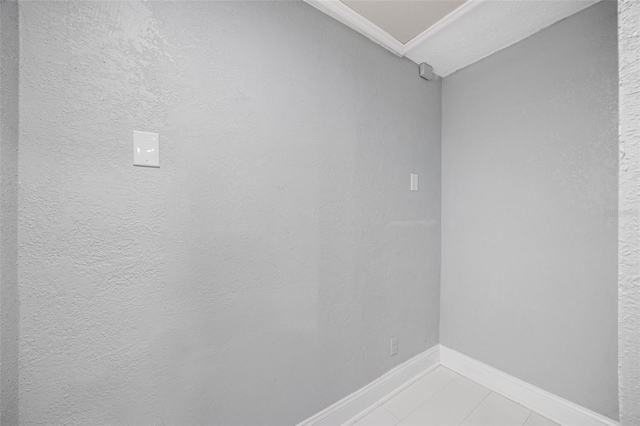 interior space featuring light tile patterned floors and baseboards