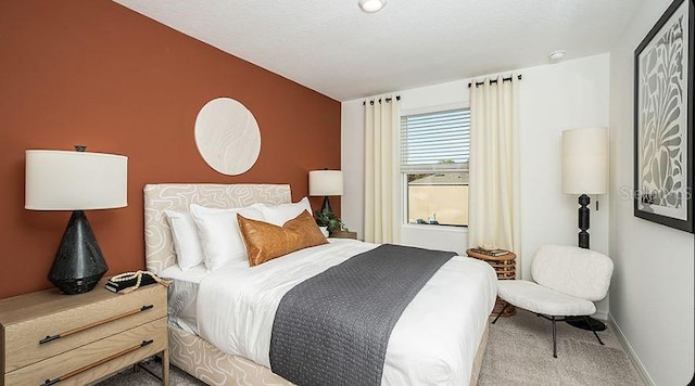 carpeted bedroom featuring baseboards