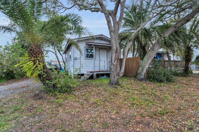 bungalow-style home featuring fence