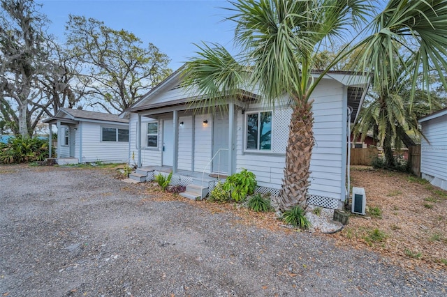 bungalow-style house with fence
