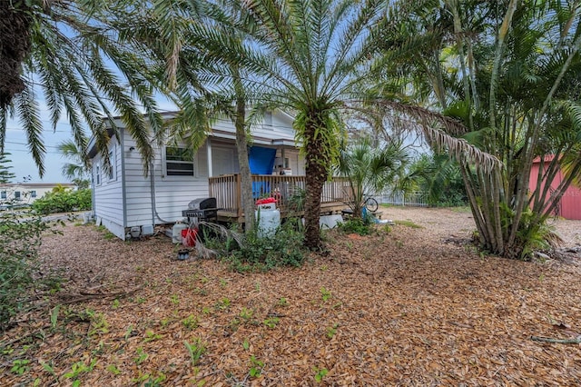 view of yard featuring fence and covered porch