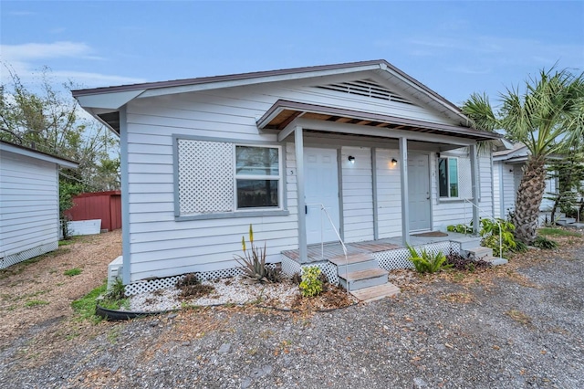 bungalow featuring fence and covered porch