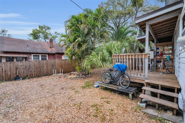 view of yard with fence and a wooden deck