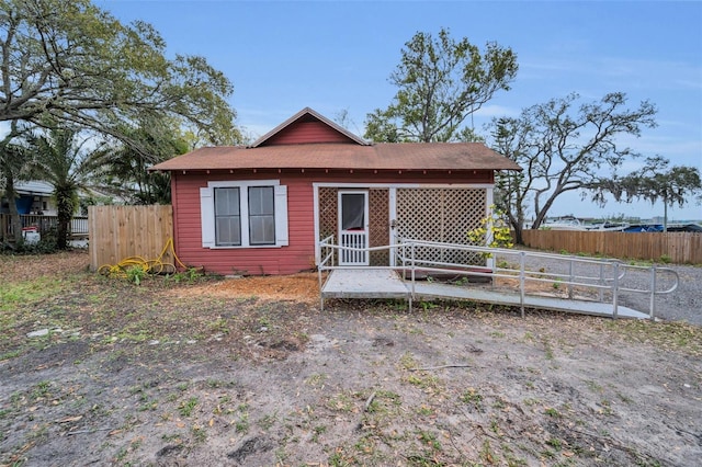 view of front of home featuring fence