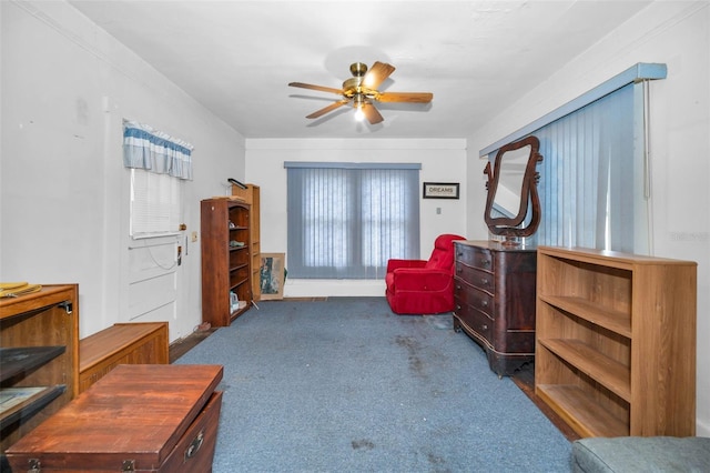 sitting room with carpet floors and a ceiling fan