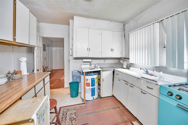 kitchen featuring white cabinetry, light countertops, white range with gas stovetop, and water heater