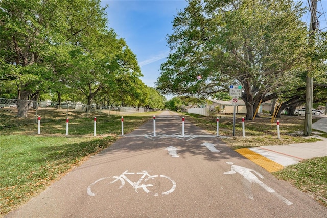 view of home's community featuring fence