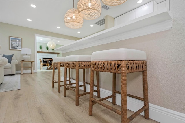 interior space featuring recessed lighting, visible vents, baseboards, and light wood-style floors