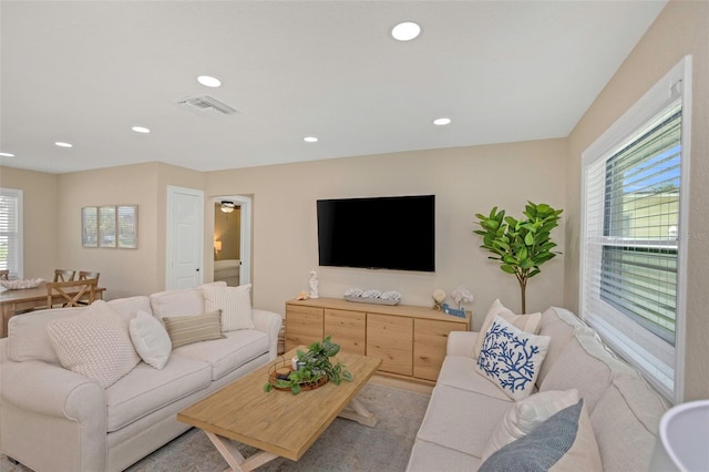 living room featuring recessed lighting and visible vents