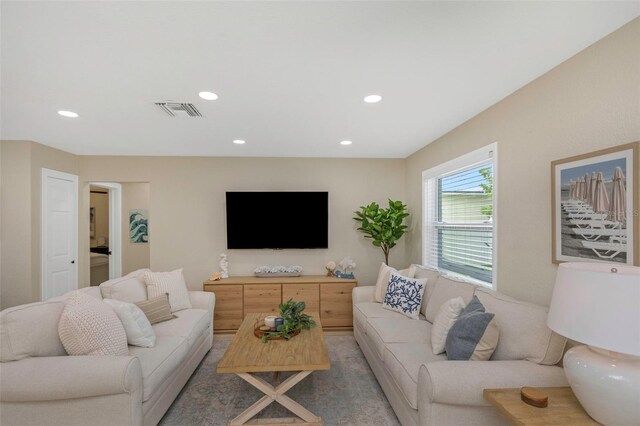 living area featuring visible vents and recessed lighting