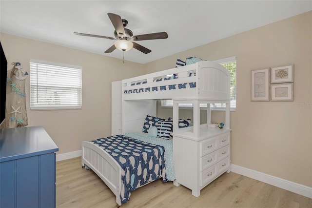 bedroom featuring light wood-style flooring, baseboards, and ceiling fan