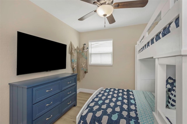 bedroom featuring baseboards, light wood-type flooring, and ceiling fan