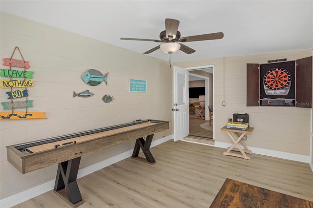 game room featuring ceiling fan, baseboards, and light wood-style flooring