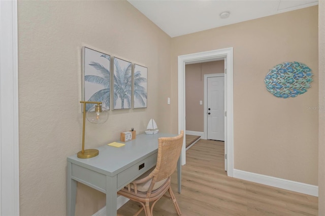 office area with baseboards and light wood-style floors