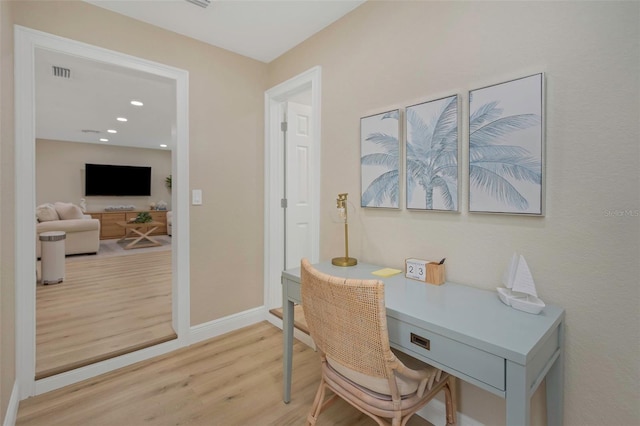 office area with light wood finished floors, visible vents, recessed lighting, and baseboards