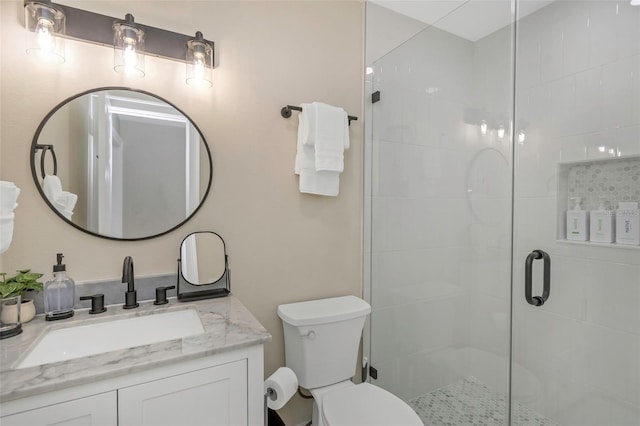 full bath featuring vanity, toilet, and a stall shower