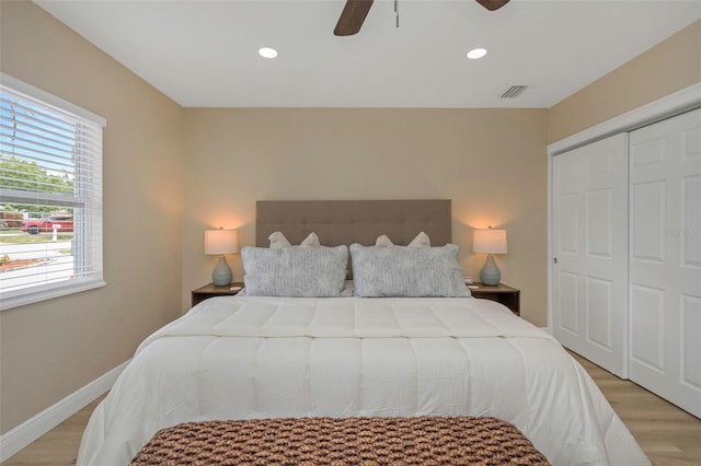 bedroom with recessed lighting, visible vents, a closet, and light wood finished floors