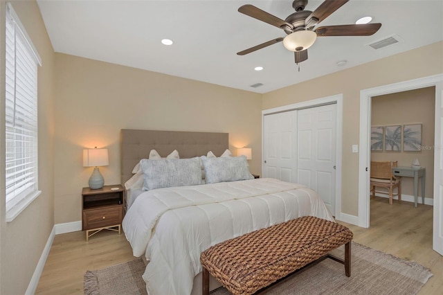 bedroom featuring visible vents, baseboards, light wood-style flooring, recessed lighting, and a closet