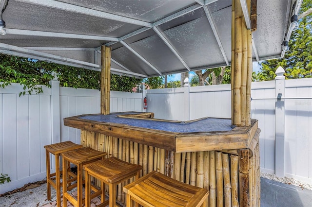 deck with outdoor dry bar and fence