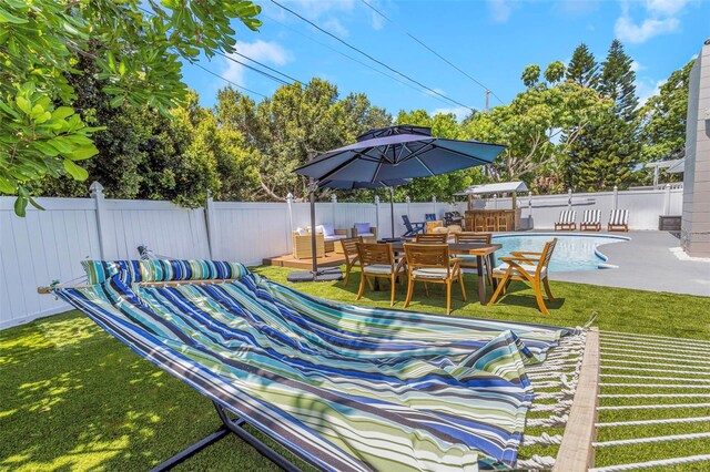 exterior space featuring an outdoor living space, a patio, a fenced backyard, a yard, and a fenced in pool