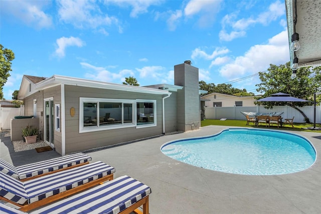 view of pool with a fenced in pool, a fenced backyard, and a patio area