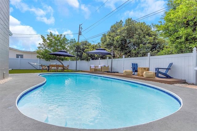 view of pool featuring a fenced in pool, an outdoor hangout area, a wooden deck, and a fenced backyard