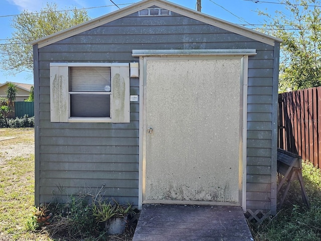 view of shed with fence