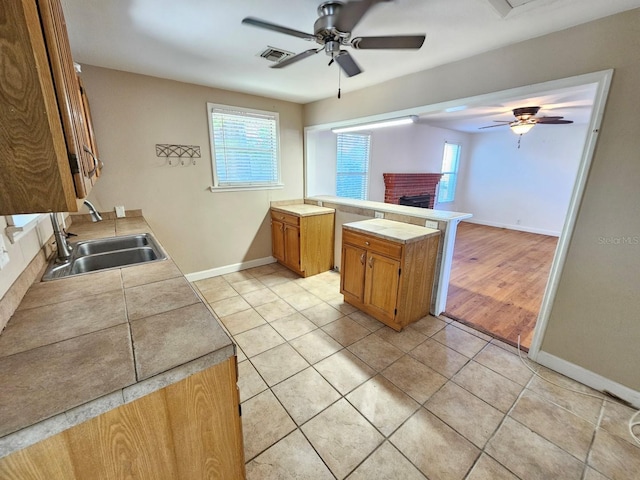 kitchen with visible vents, a healthy amount of sunlight, a ceiling fan, and a sink