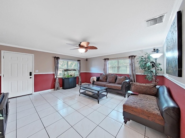 living room featuring crown molding, light tile patterned flooring, a healthy amount of sunlight, and visible vents