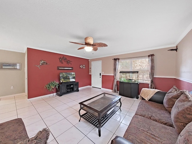 living area featuring light tile patterned flooring, baseboards, crown molding, and ceiling fan