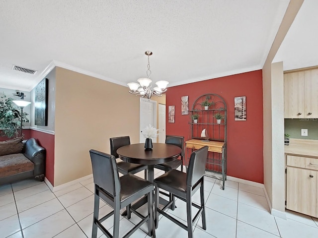 dining area featuring an inviting chandelier, crown molding, light tile patterned floors, and visible vents