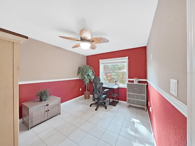 office area with light tile patterned floors, baseboards, and a ceiling fan