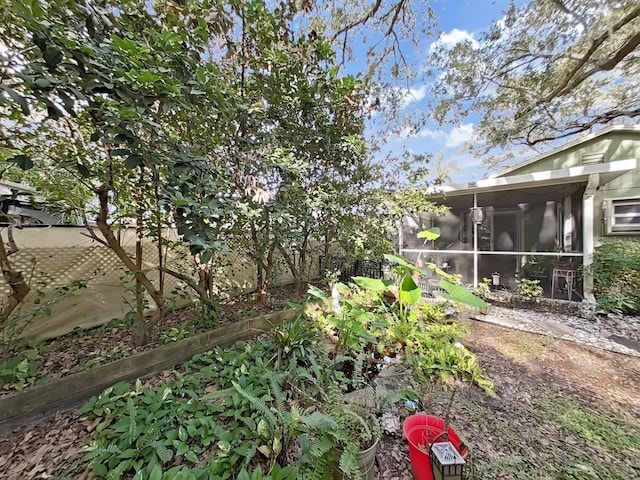 view of yard with fence and a sunroom