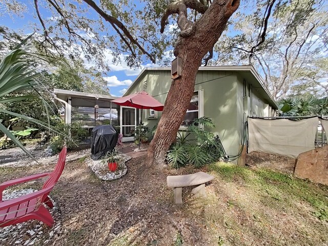 rear view of property featuring a sunroom