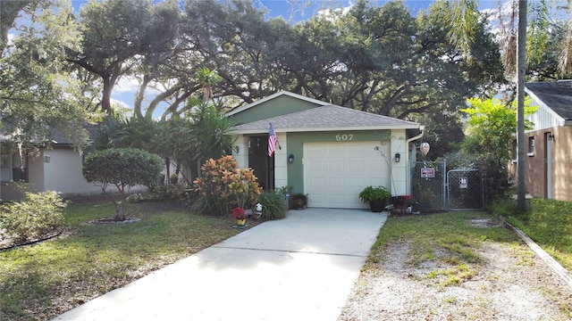 ranch-style house featuring a front yard, a gate, driveway, an attached garage, and a shingled roof