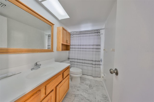 bathroom featuring a shower with shower curtain, toilet, marble finish floor, and vanity