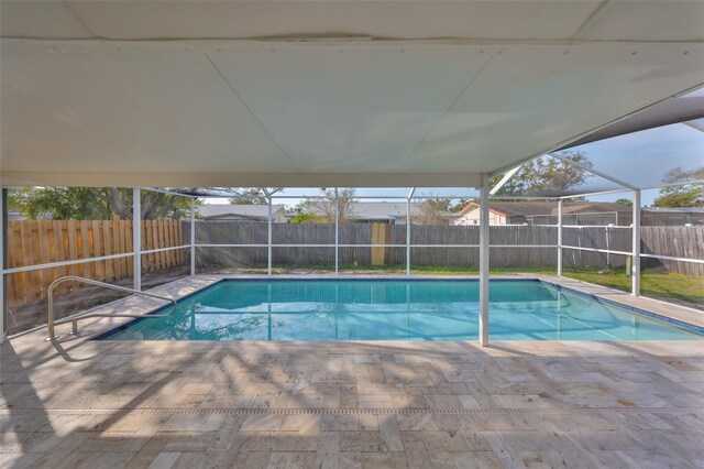 view of pool with a lanai, a fenced in pool, and a fenced backyard