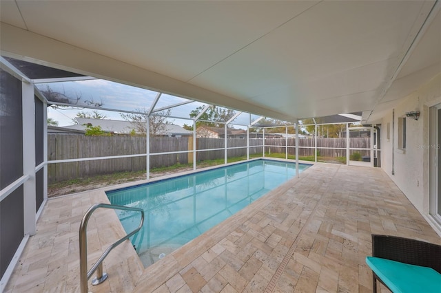 view of pool featuring a patio area, a lanai, and a fenced backyard