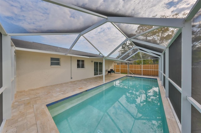 view of swimming pool with a patio area, a fenced in pool, a lanai, and fence