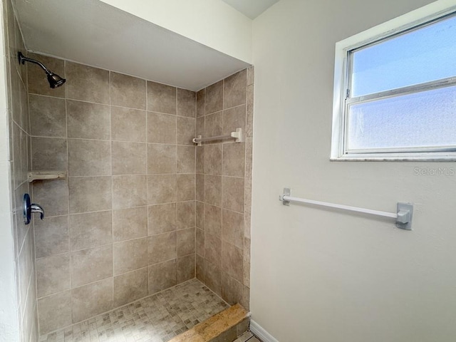 bathroom with a tile shower