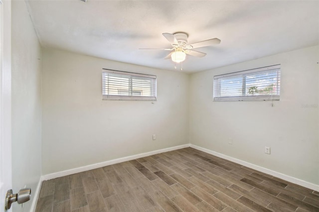 empty room with ceiling fan, baseboards, and wood finished floors