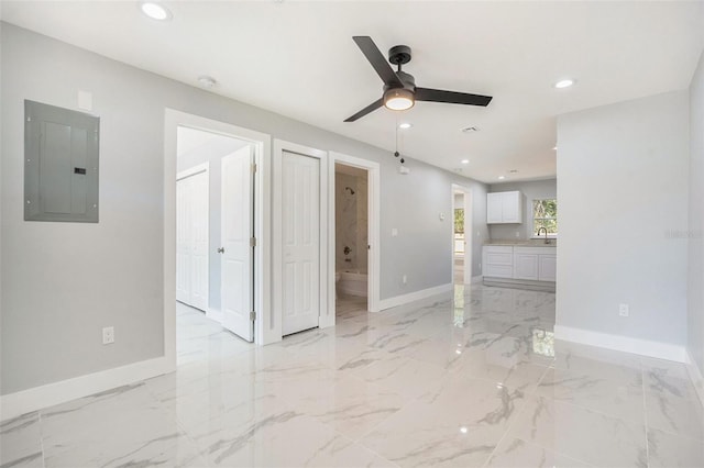 unfurnished room featuring baseboards, ceiling fan, electric panel, recessed lighting, and marble finish floor